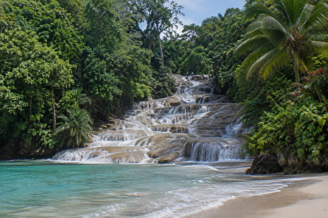 Waterfall terraces of Dunn's River Falls emptying toward the beach and the sea