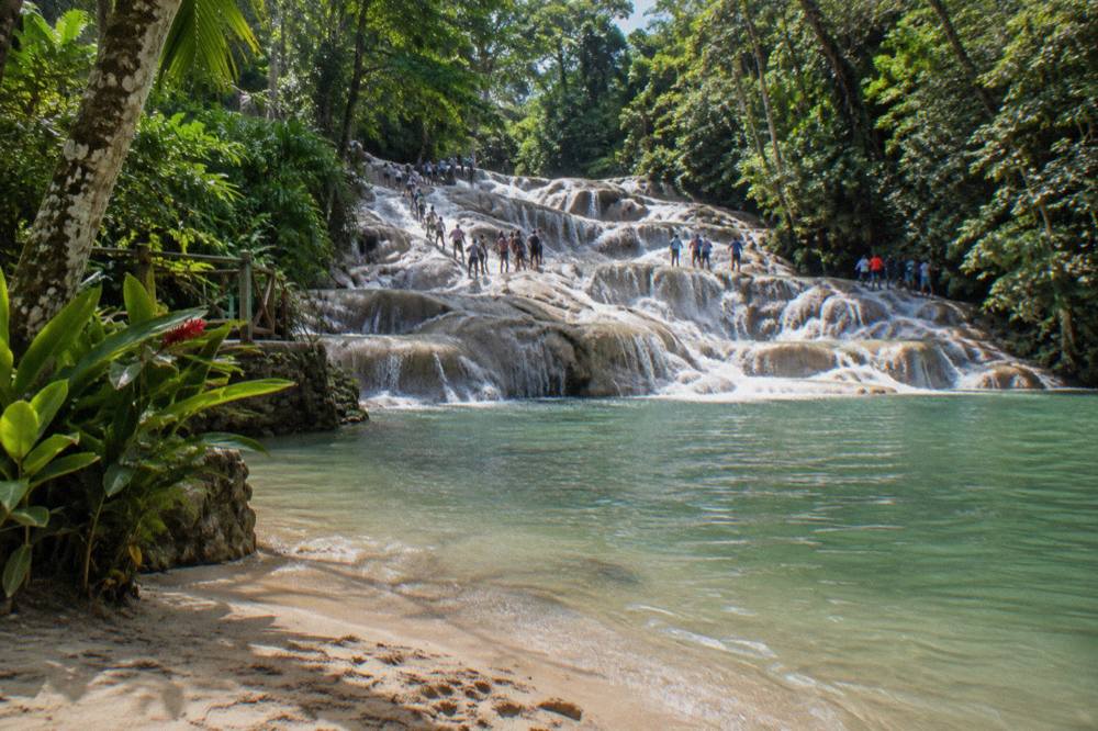 Tiered limestone waterfall cascading into a large natural pool
