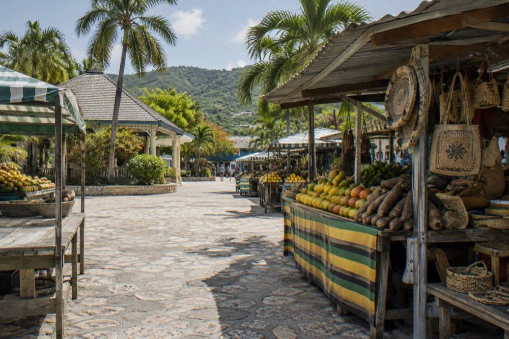 Colorful market stalls with fruit and crafts in a Caribbean town square