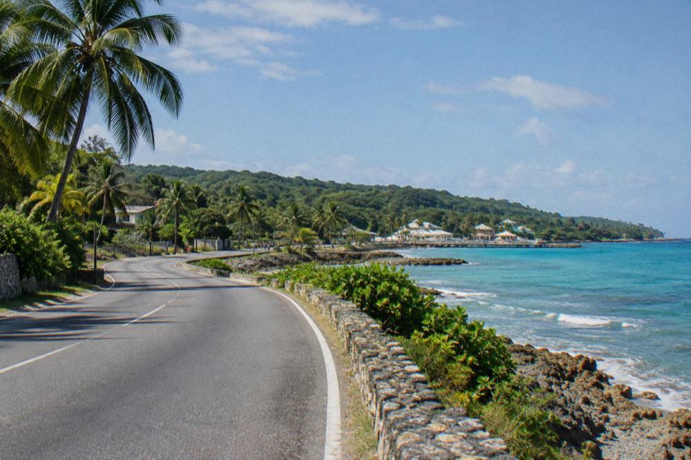 Coastal highway curving along Jamaica's north shore with the sea on one side