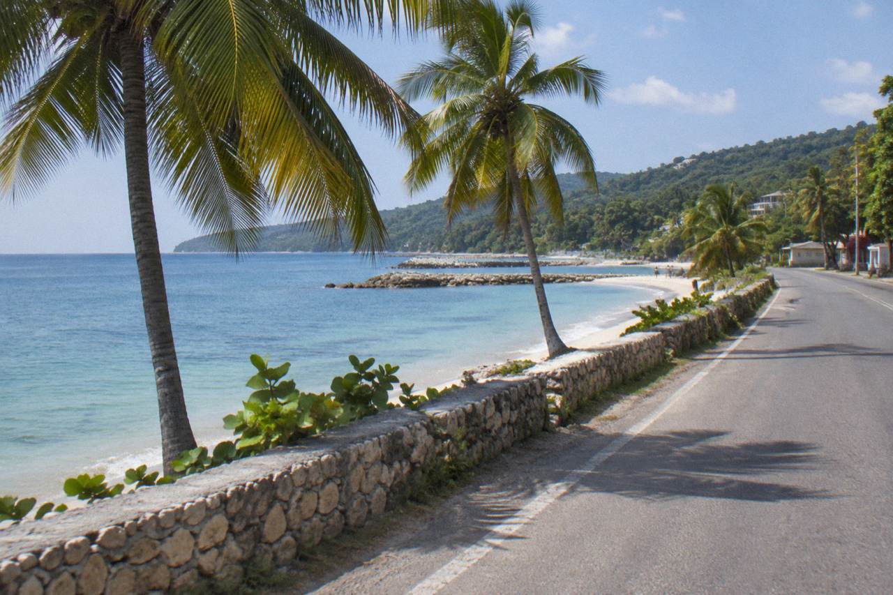 Coastal highway along the north shore of Jamaica near Runaway Bay with calm blue water
