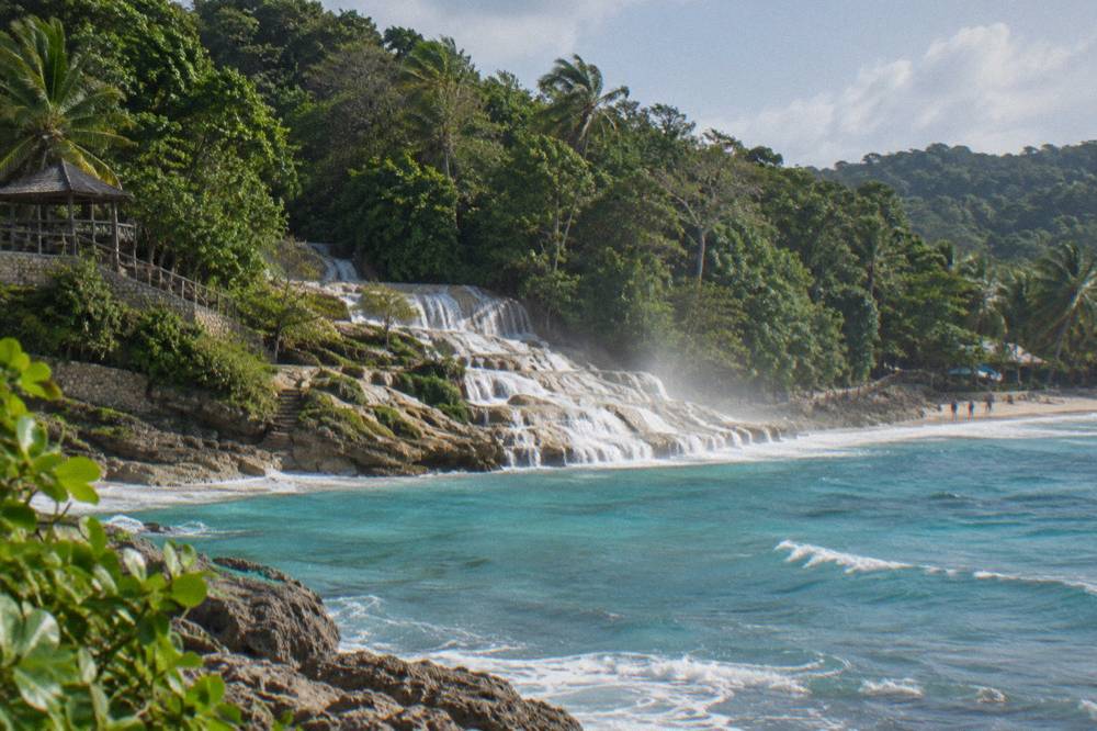 Waterfall terraces emptying onto a sandy beach beside the Caribbean Sea